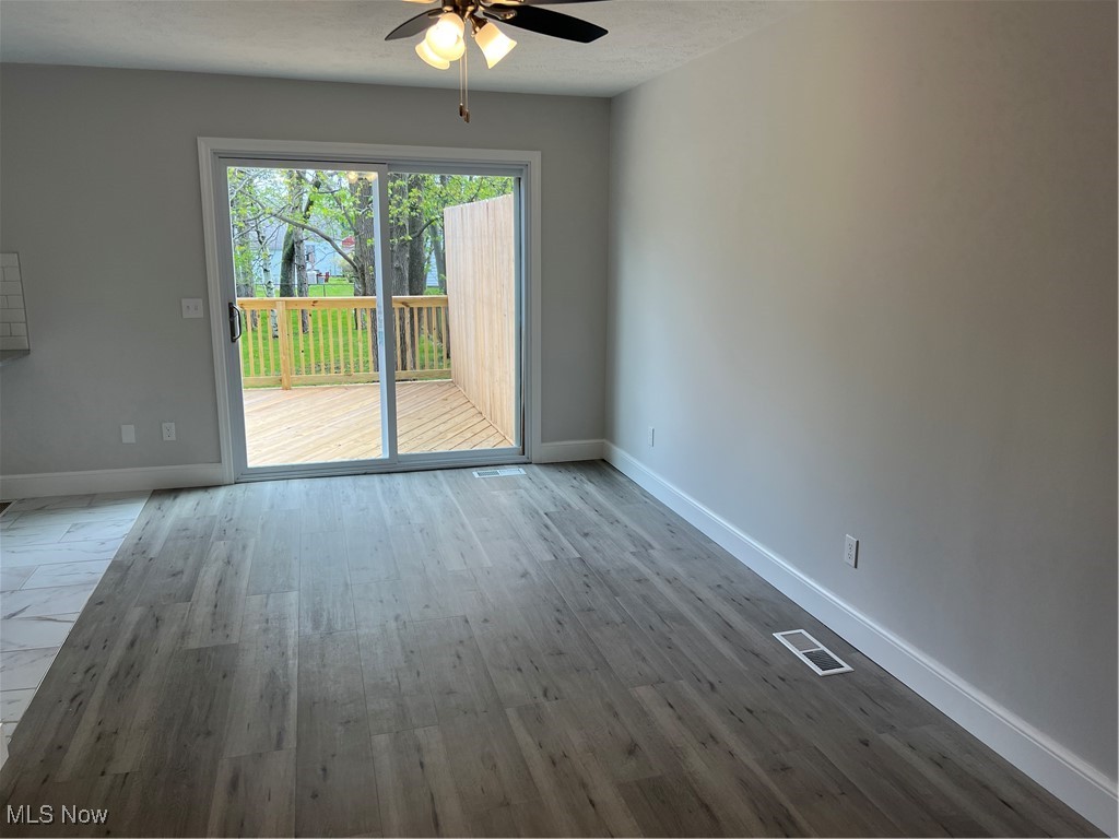 1279 Lander Road Cleveland, OH 44124 - Photo 19 of 37 Spare room featuring baseboards, ceiling fan, visible vents, and wood finished floors