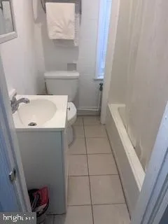 a bathroom with a sink a toilet and bathtub