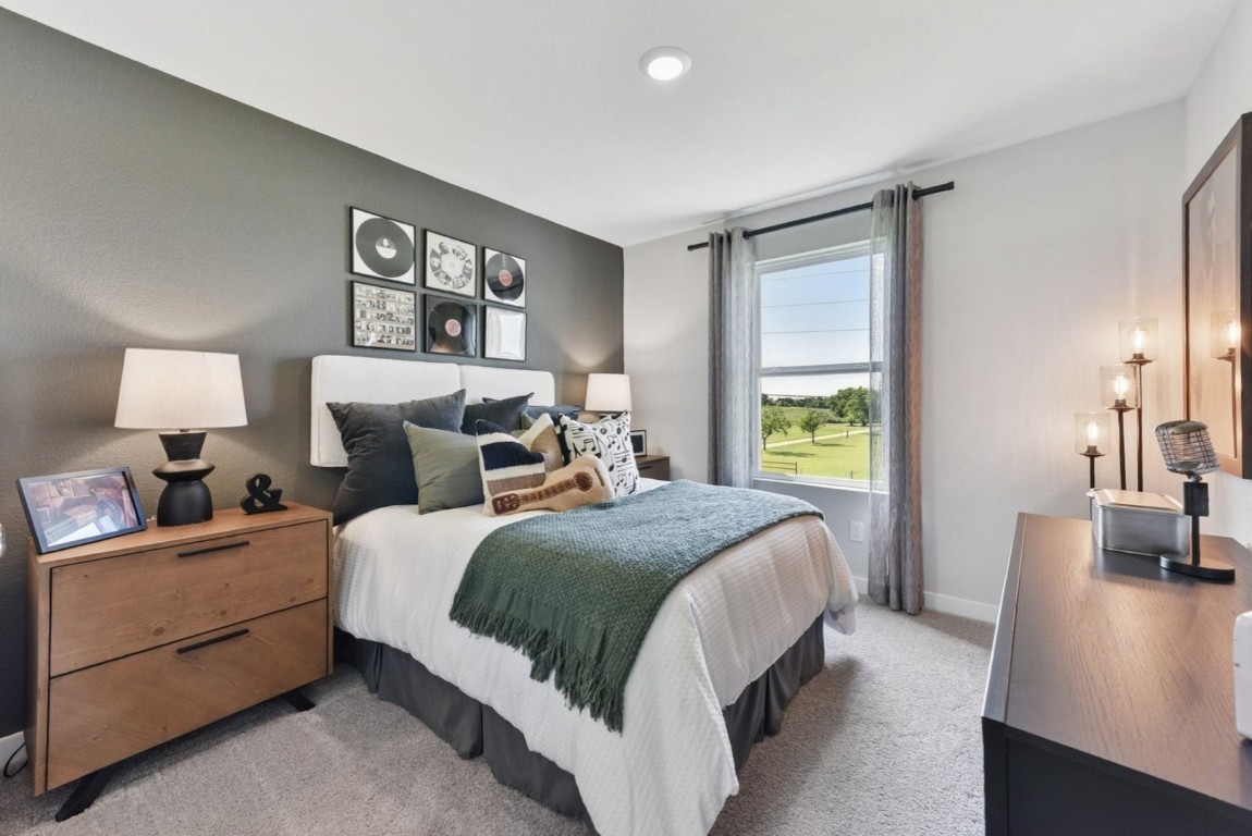 1220 Lavender Way Georgetown, TX 78628 - Photo 16 of 27 a bedroom with a bed and wooden floor