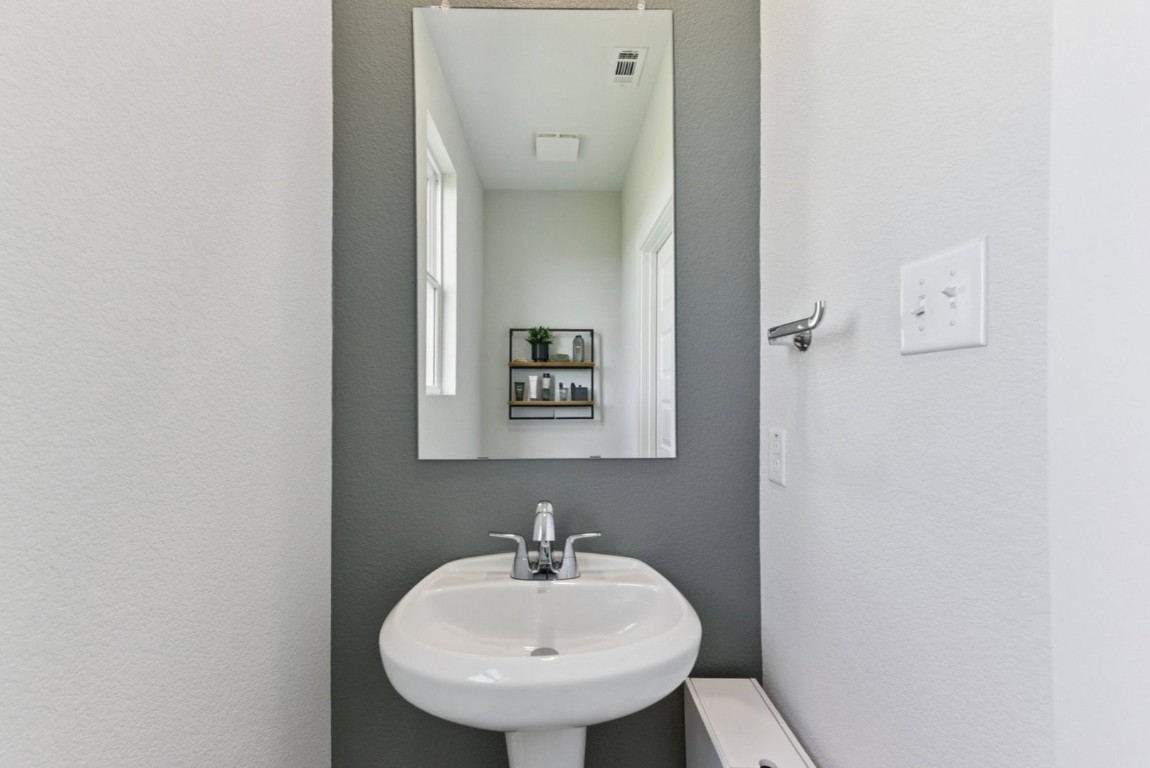 1220 Lavender Way Georgetown, TX 78628 - Photo 18 of 27 a bathroom with a sink and a mirror