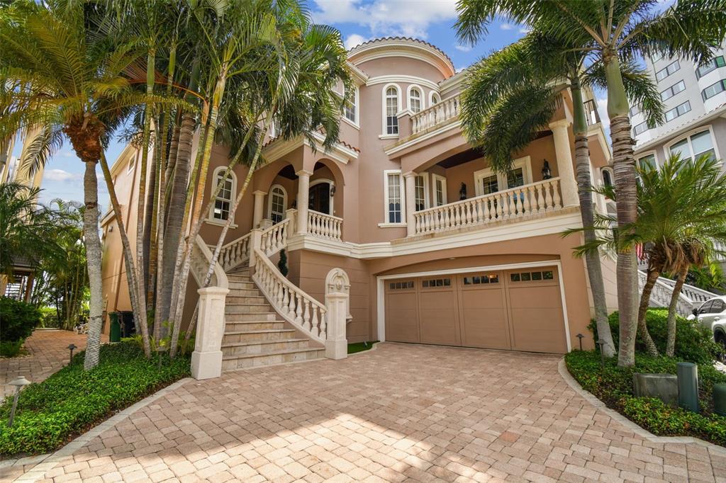 a front view of a house with a yard and trees