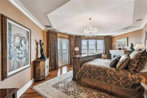 a front view of a house with a yard and palm trees