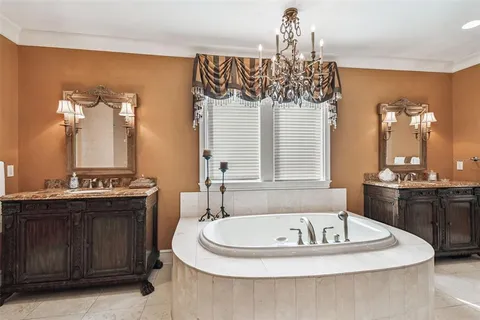 a kitchen with a stove a refrigerator and a sink with large cabinets