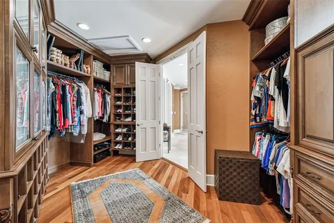 a view of a dining room with furniture a chandelier and wooden floor