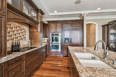 a bathroom with a granite countertop sink toilet a mirror and shower