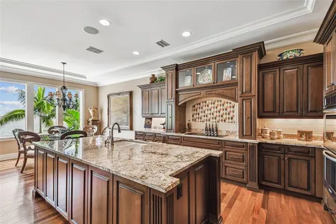 a bathroom with a granite countertop sink a toilet and shower