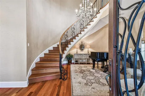 an aerial view of residential houses with outdoor space and ocean view