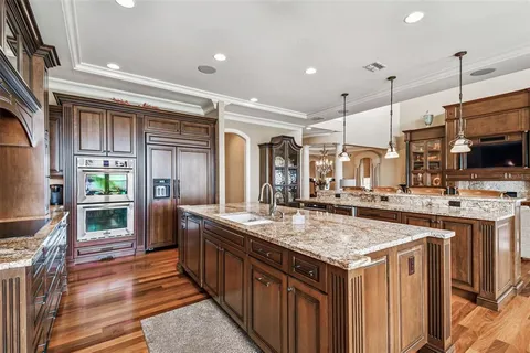 a bedroom with a large bed and a chandelier