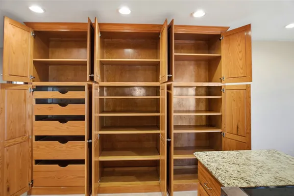 a kitchen with stainless steel appliances granite countertop a refrigerator a oven and a sink