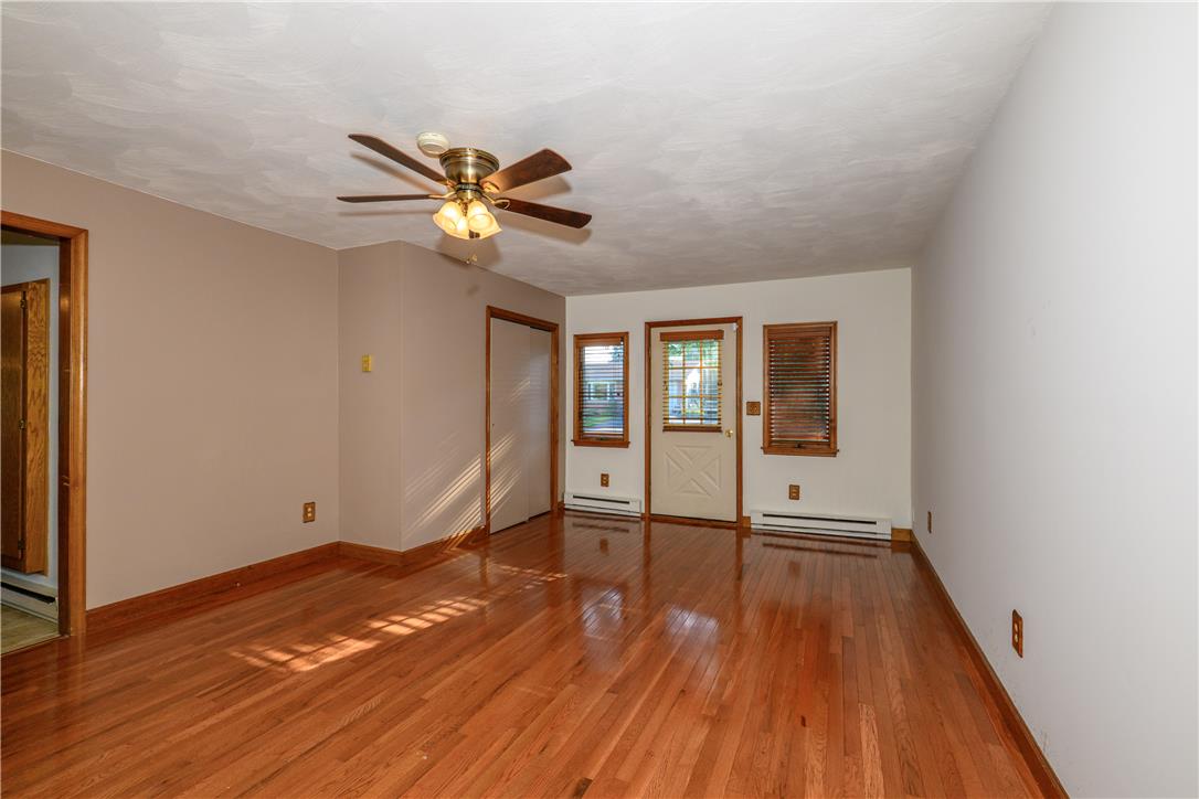 1644 9th Street Bethlehem, PA 18020 - Photo 10 of 27 A living space offers warm hardwood floors, natural light, and a functional ceiling fan for comfort.