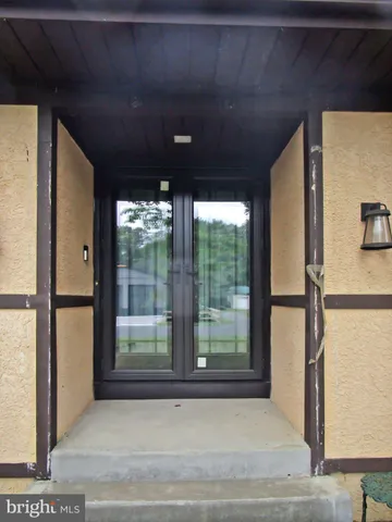 a view of a room with a fan and a window