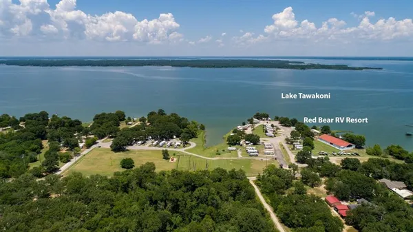 a view of a houses with a yard and lake view
