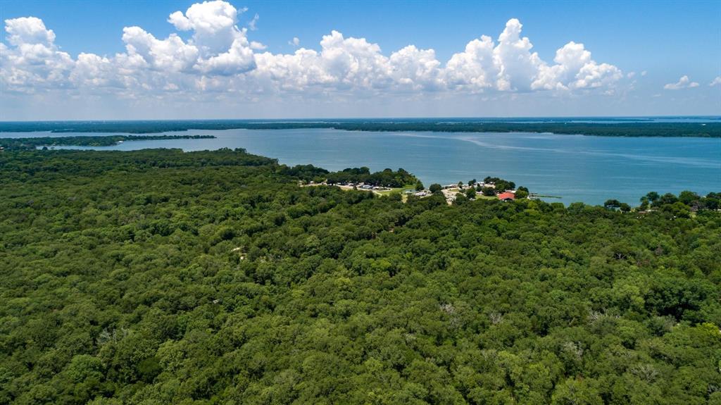 2 County Road 3706 Quinlan, TX 75474 - Photo 7 of 11 a view of a lake in middle of forest
