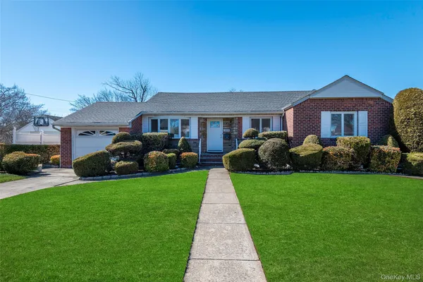 a front view of a house with a garden