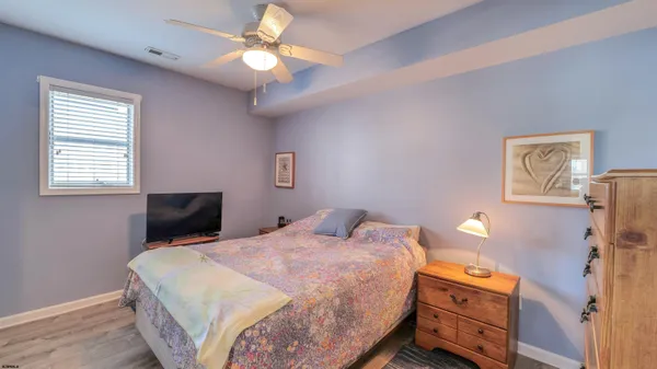 a bedroom with a bed and a dresser in it