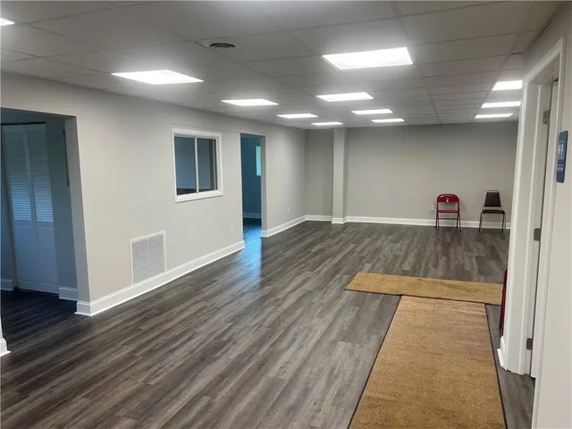 a view of a room with wooden floor