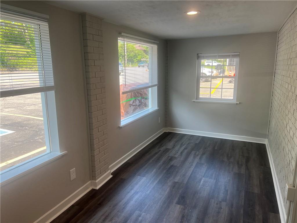 3136 Brodhead Road Aliquippa, PA 15001 - Photo 4 of 8 a view of an empty room with wooden floor and a window