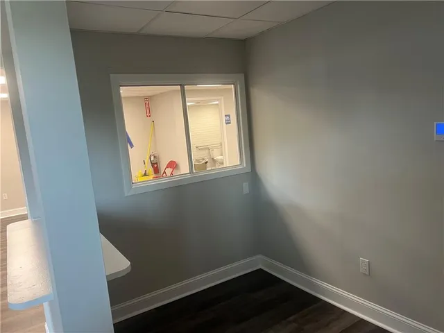 a small space with wooden floor and a window