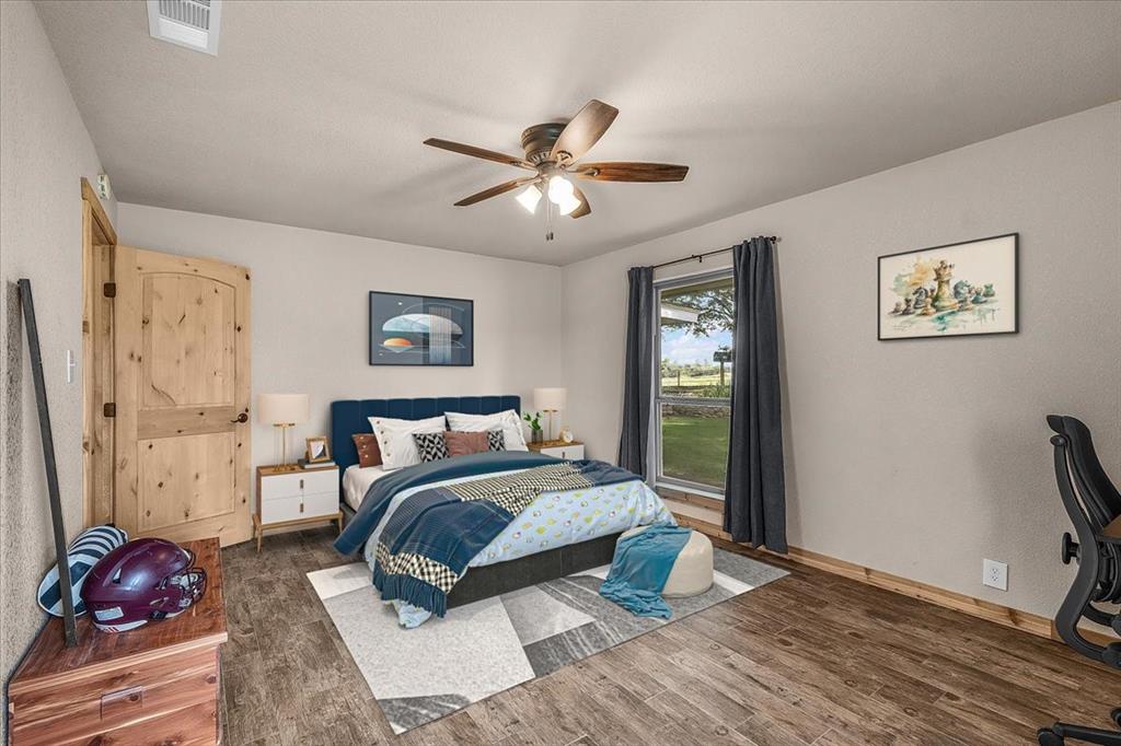 1508 Poolville Cut Off Road Poolville, TX 76487 - Photo 24 of 39 Bedroom featuring wood finished floors and a ceiling fan
