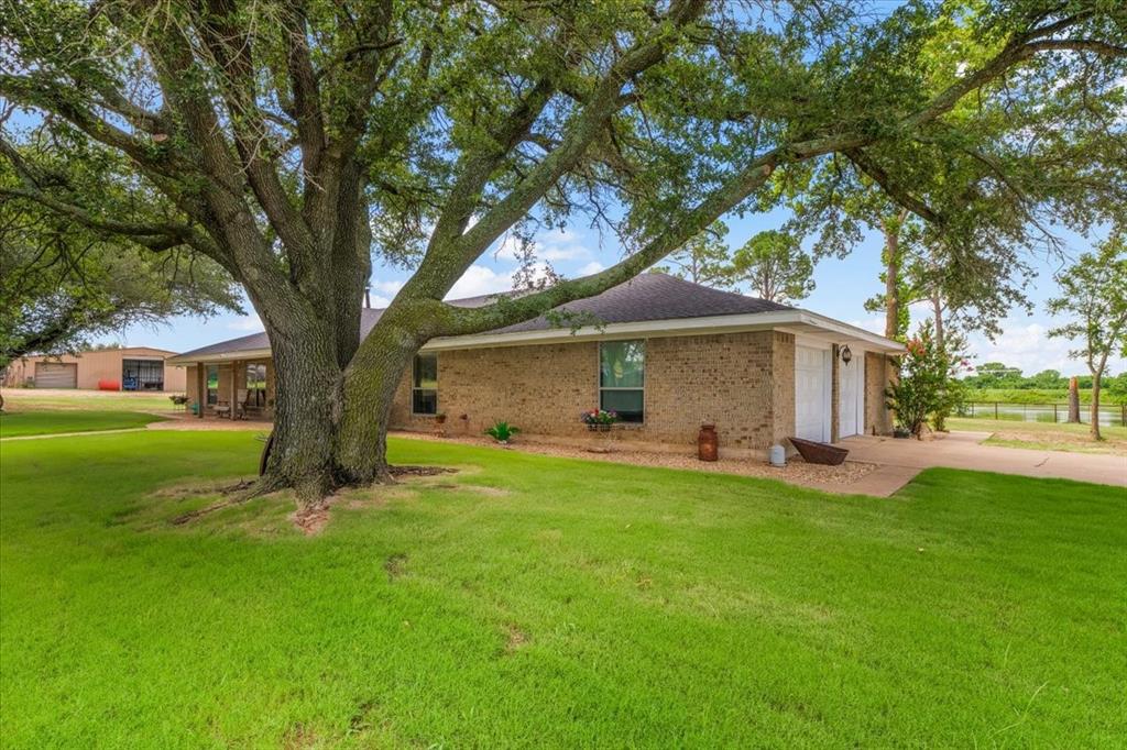 1508 Poolville Cut Off Road Poolville, TX 76487 - Photo 26 of 39 View of side of home featuring concrete driveway and garage
