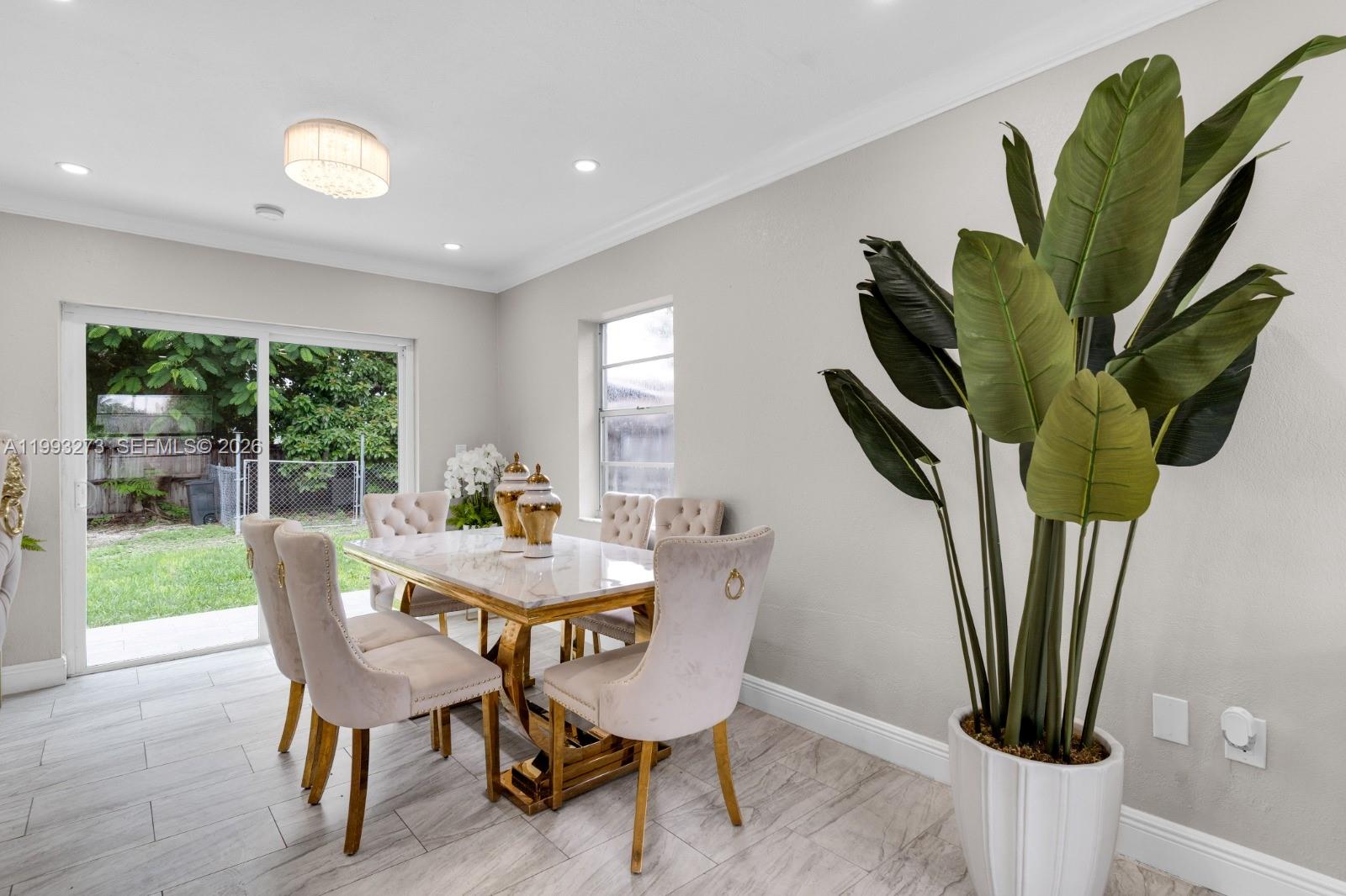 30534 Southwest 155th Court Homestead, FL 33033 - Photo 11 of 33 a dining room with furniture and a potted plant