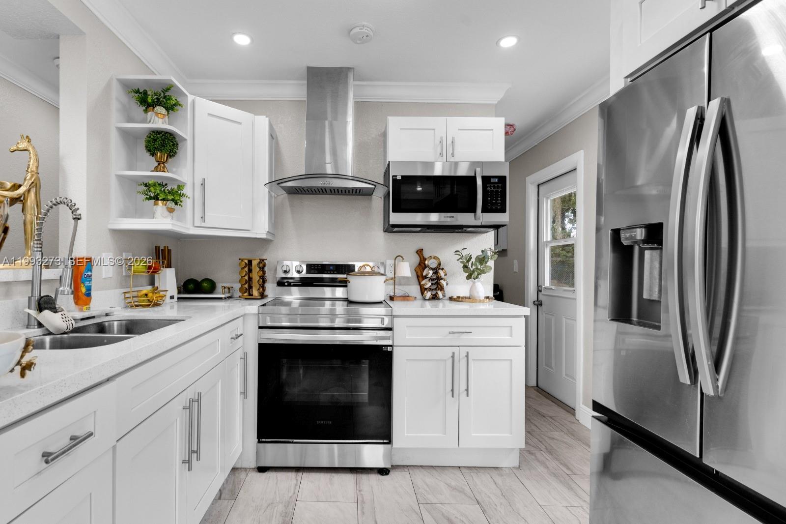 30534 Southwest 155th Court Homestead, FL 33033 - Photo 12 of 33 a kitchen with stainless steel appliances granite countertop a refrigerator sink and microwave