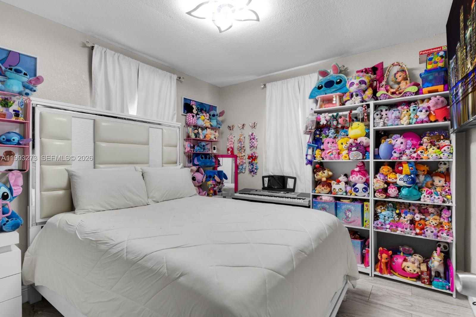 30534 Southwest 155th Court Homestead, FL 33033 - Photo 19 of 33 a bedroom with bed and a book shelf