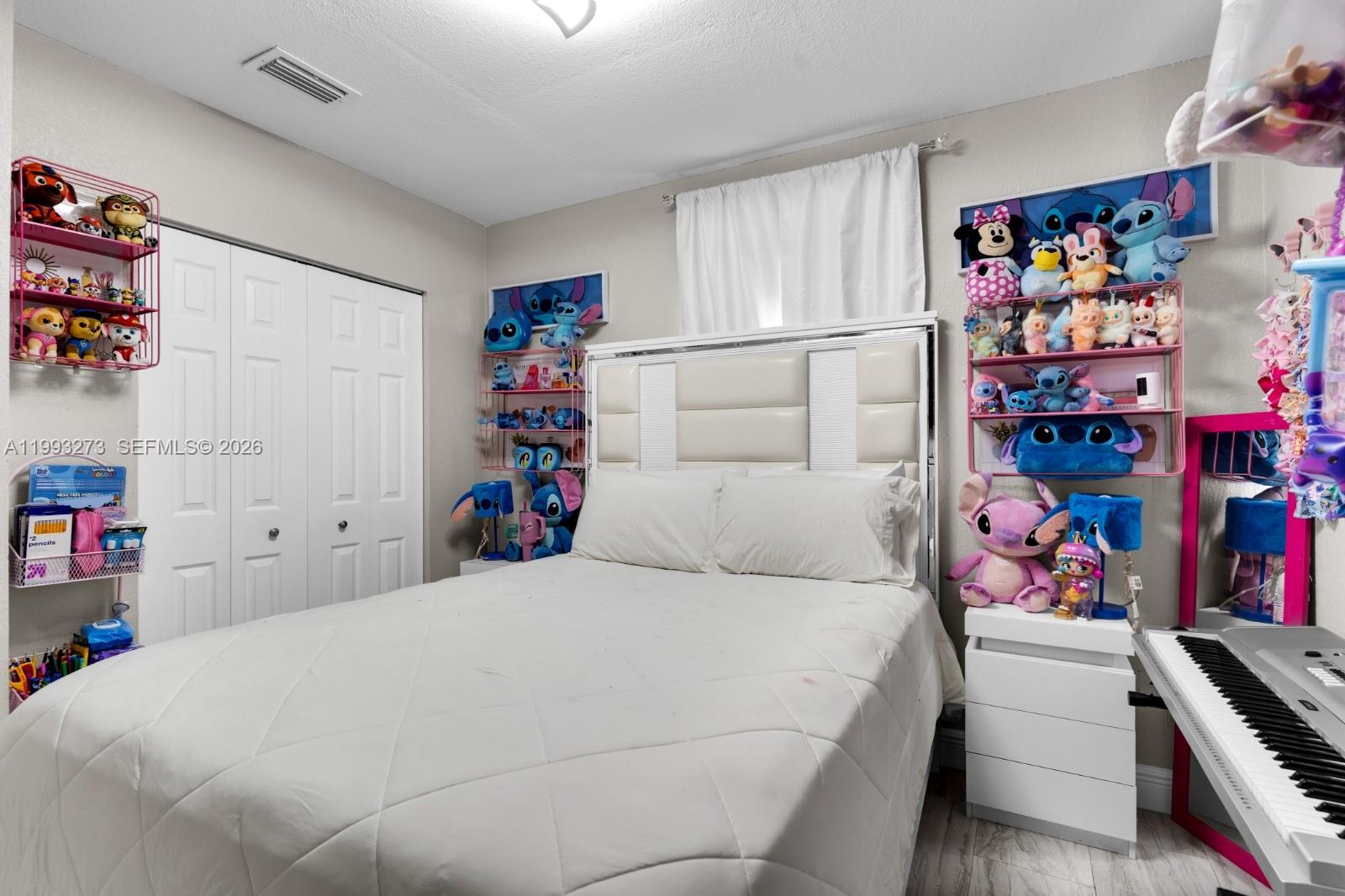 30534 Southwest 155th Court Homestead, FL 33033 - Photo 20 of 33 a bedroom with bed with lots of baby toys