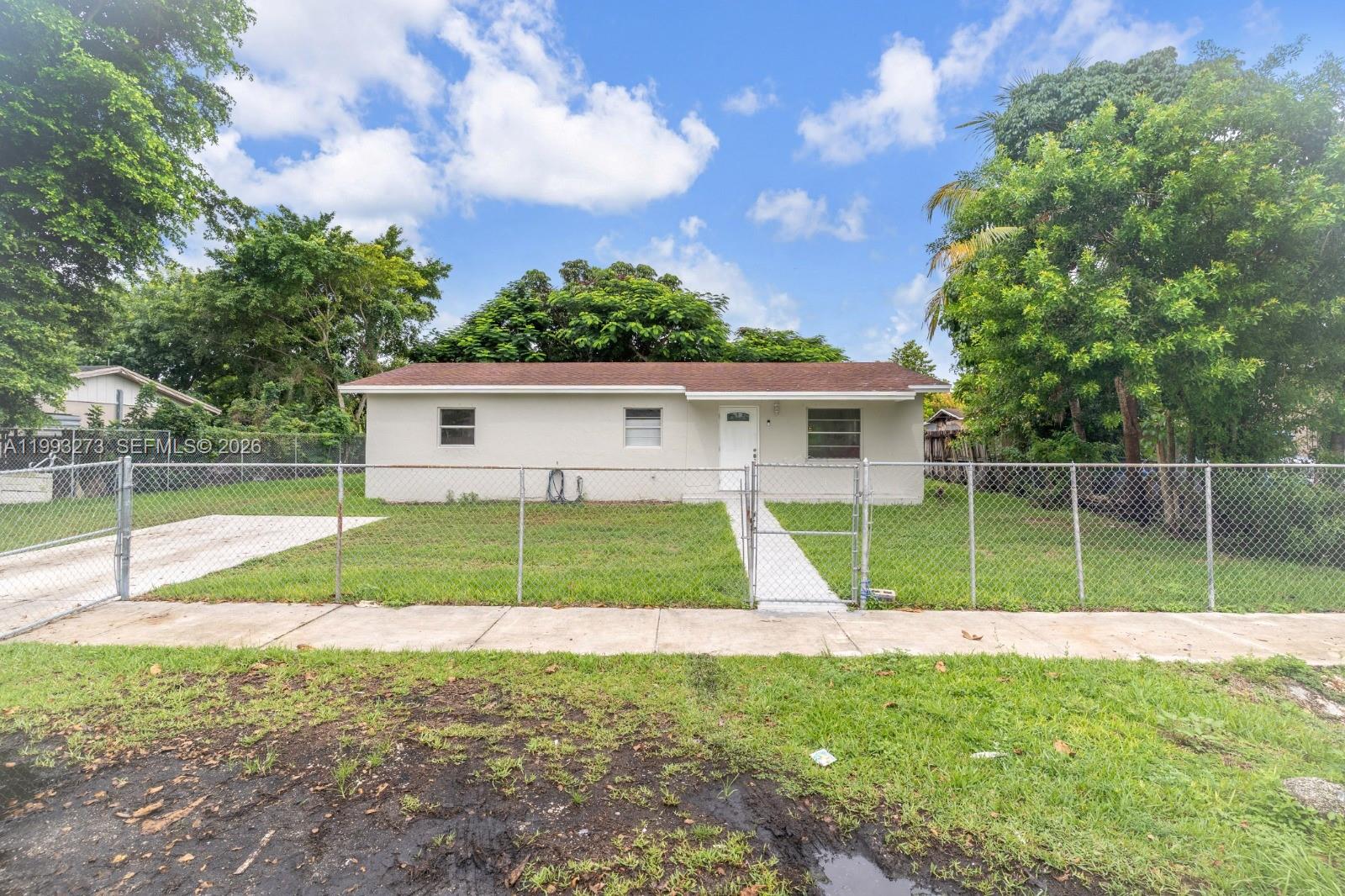 30534 Southwest 155th Court Homestead, FL 33033 - Photo 3 of 33 a view of a house with a backyard and a large tree