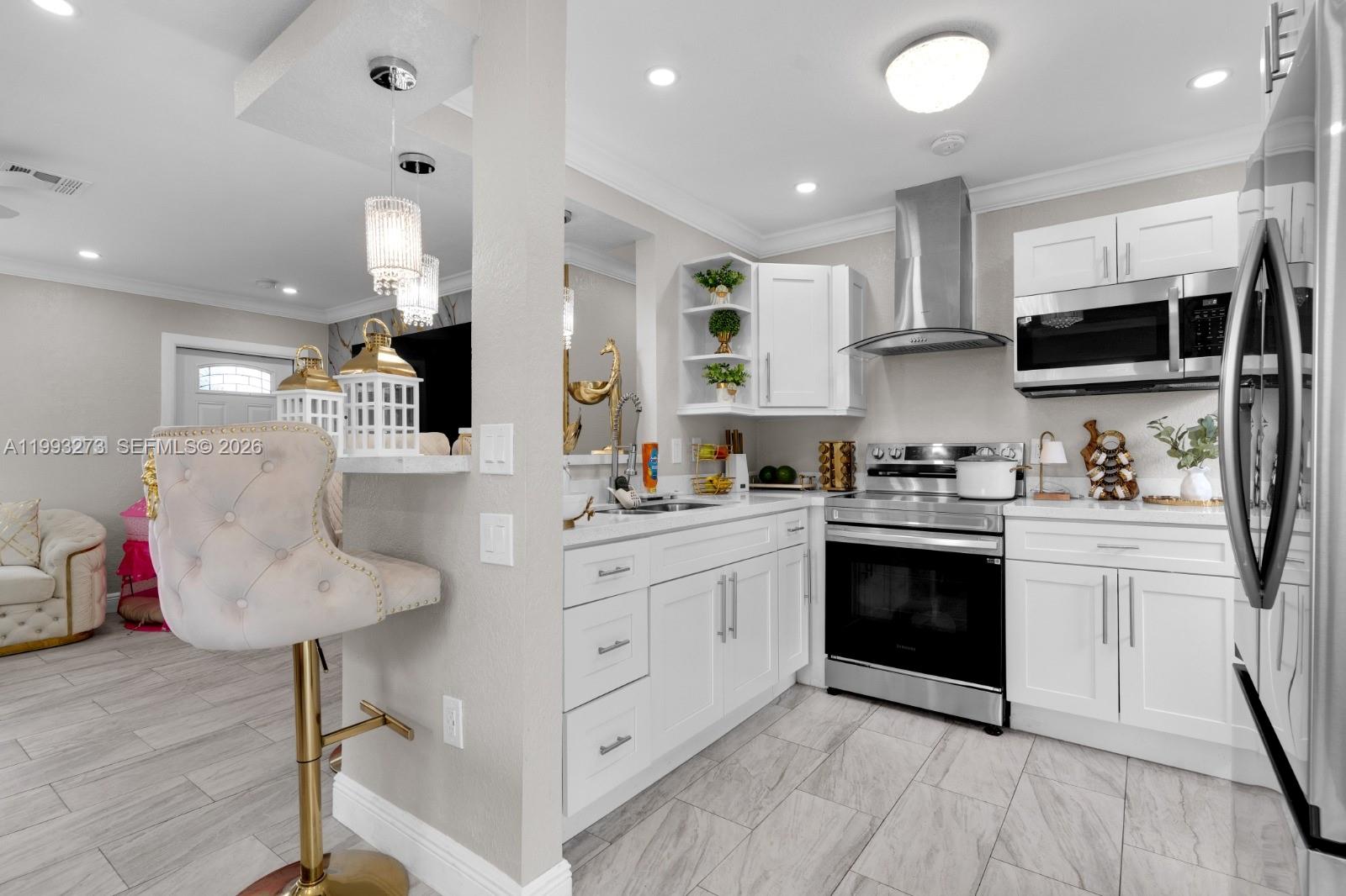 30534 Southwest 155th Court Homestead, FL 33033 - Photo 10 of 33 a kitchen with stainless steel appliances kitchen island granite countertop a stove and a sink