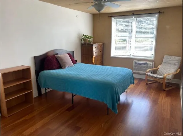 a bedroom with a bed and a chair