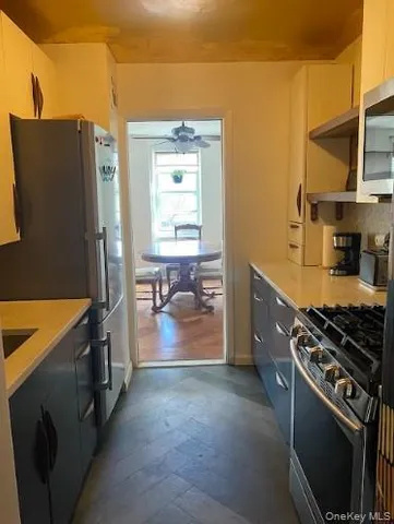 a kitchen that has a sink a stove and a refrigerator