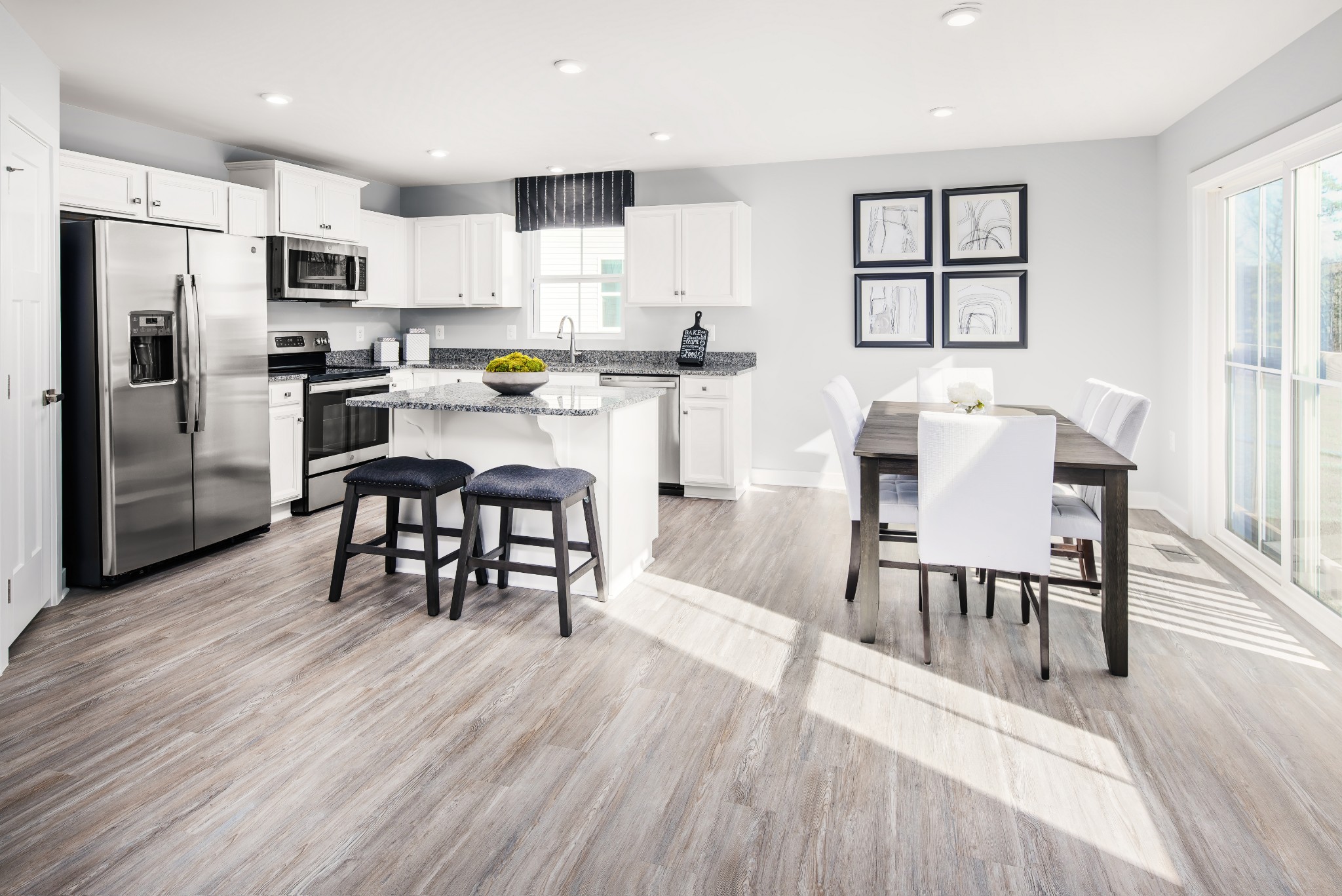 734 Cottage Drive Columbia, TN 38401 - Photo 3 of 10 a kitchen with stainless steel appliances a dining table chairs refrigerator and sink