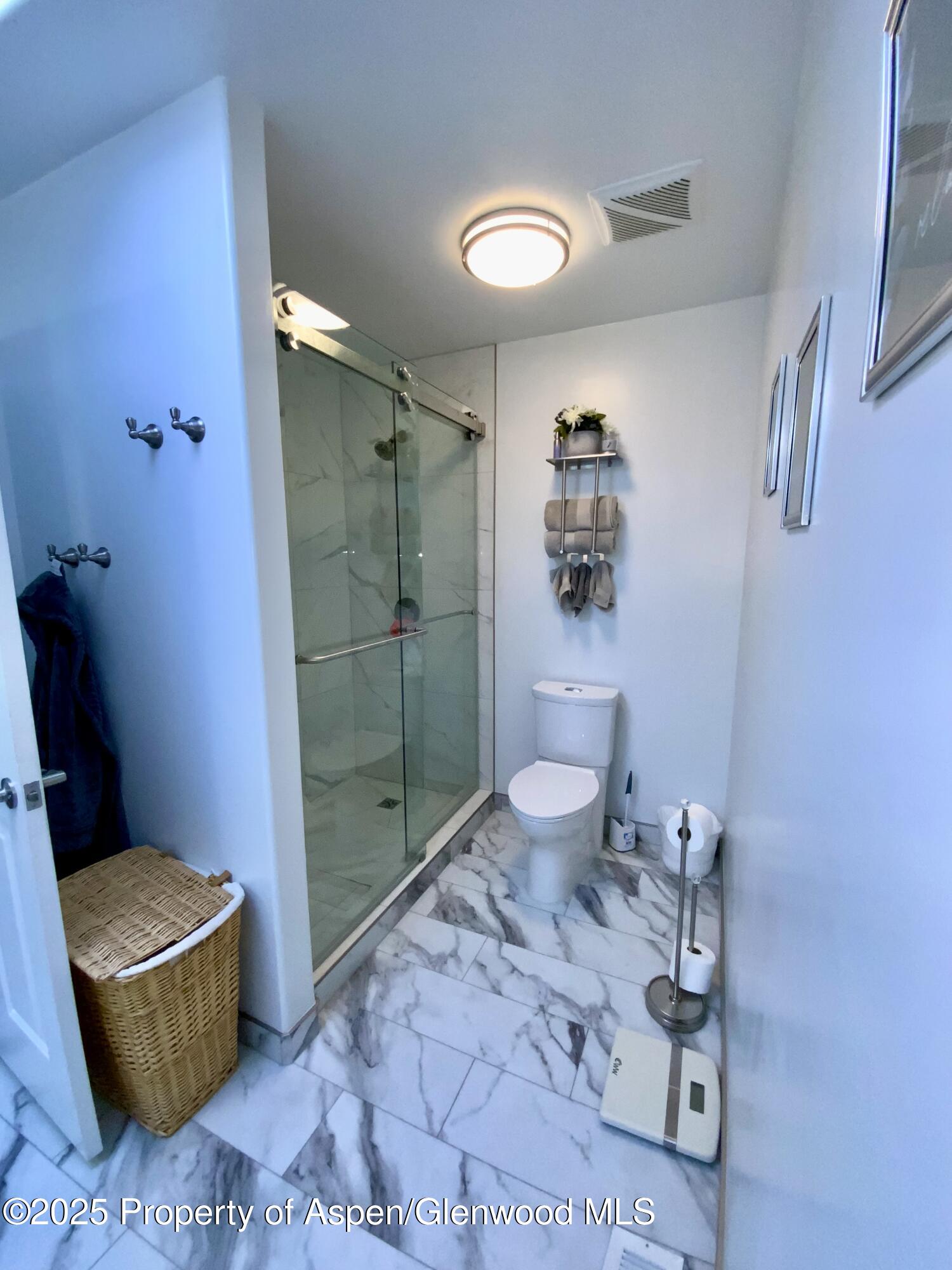 660 Aspen Avenue Rifle, CO 81650 - Photo 11 of 30 a bathroom with a granite countertop toilet a sink and a shower