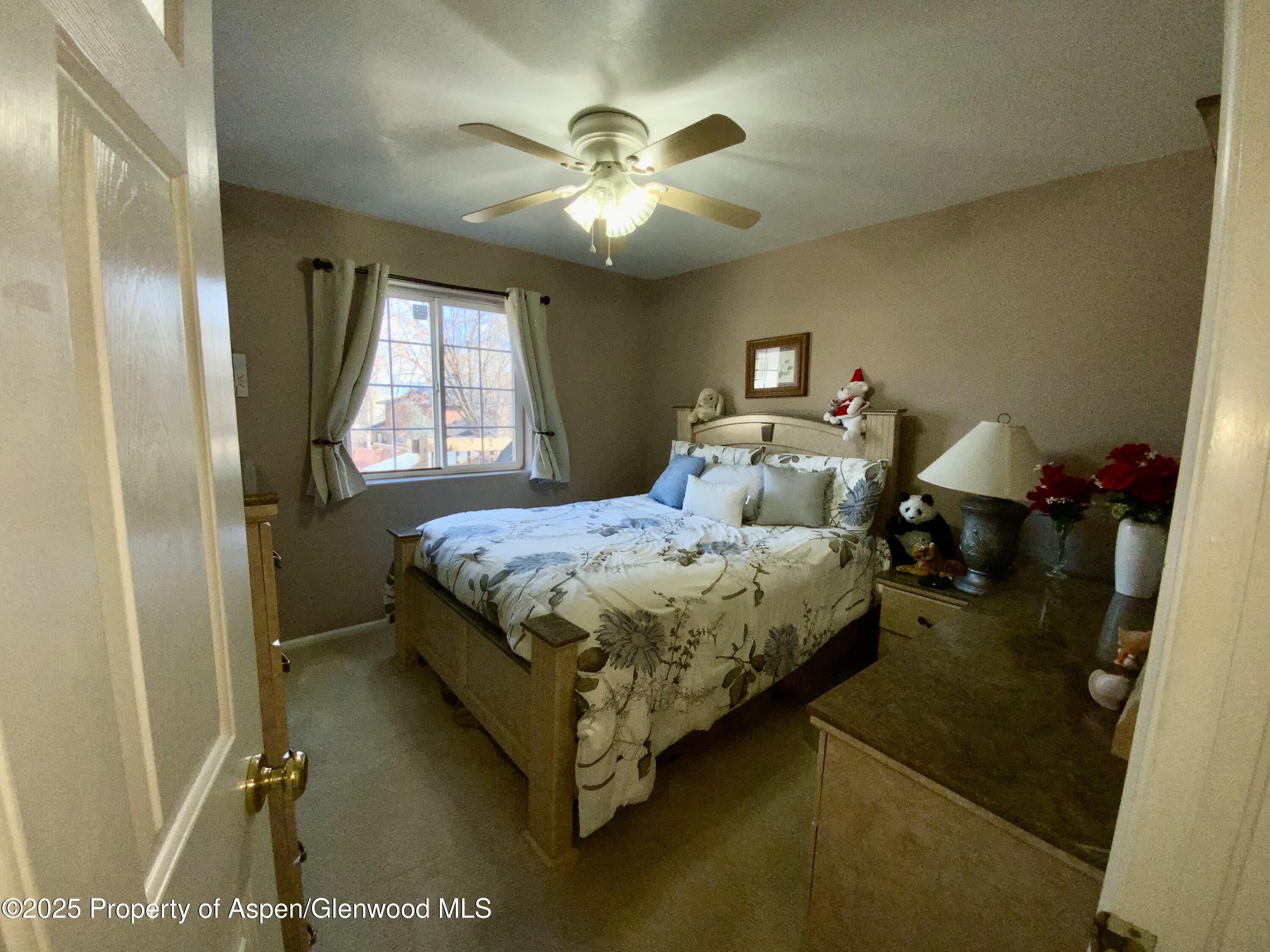 660 Aspen Avenue Rifle, CO 81650 - Photo 12 of 30 a bedroom with a bed and window
