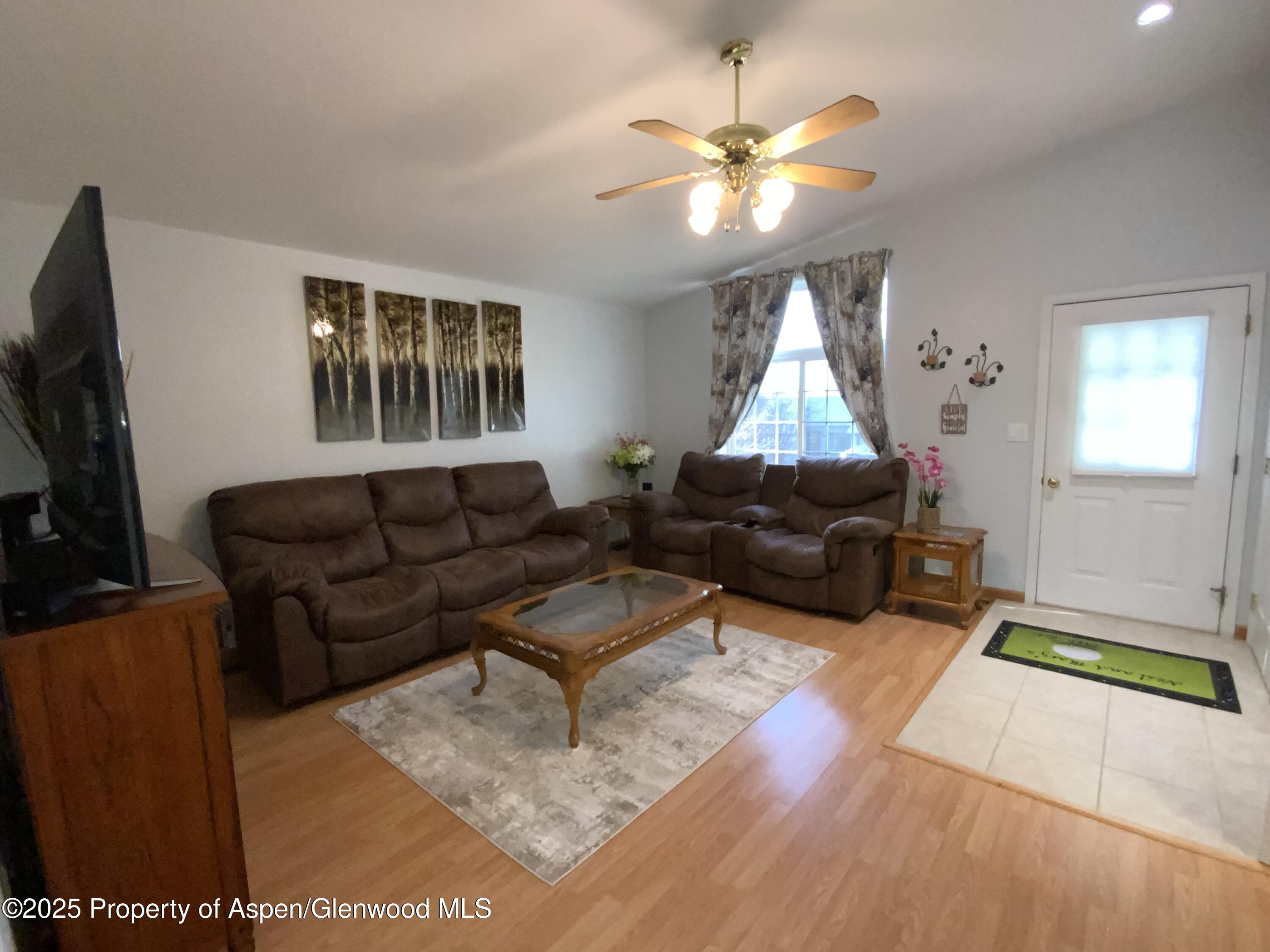 660 Aspen Avenue Rifle, CO 81650 - Photo 3 of 30 a living room with furniture and a flat screen tv