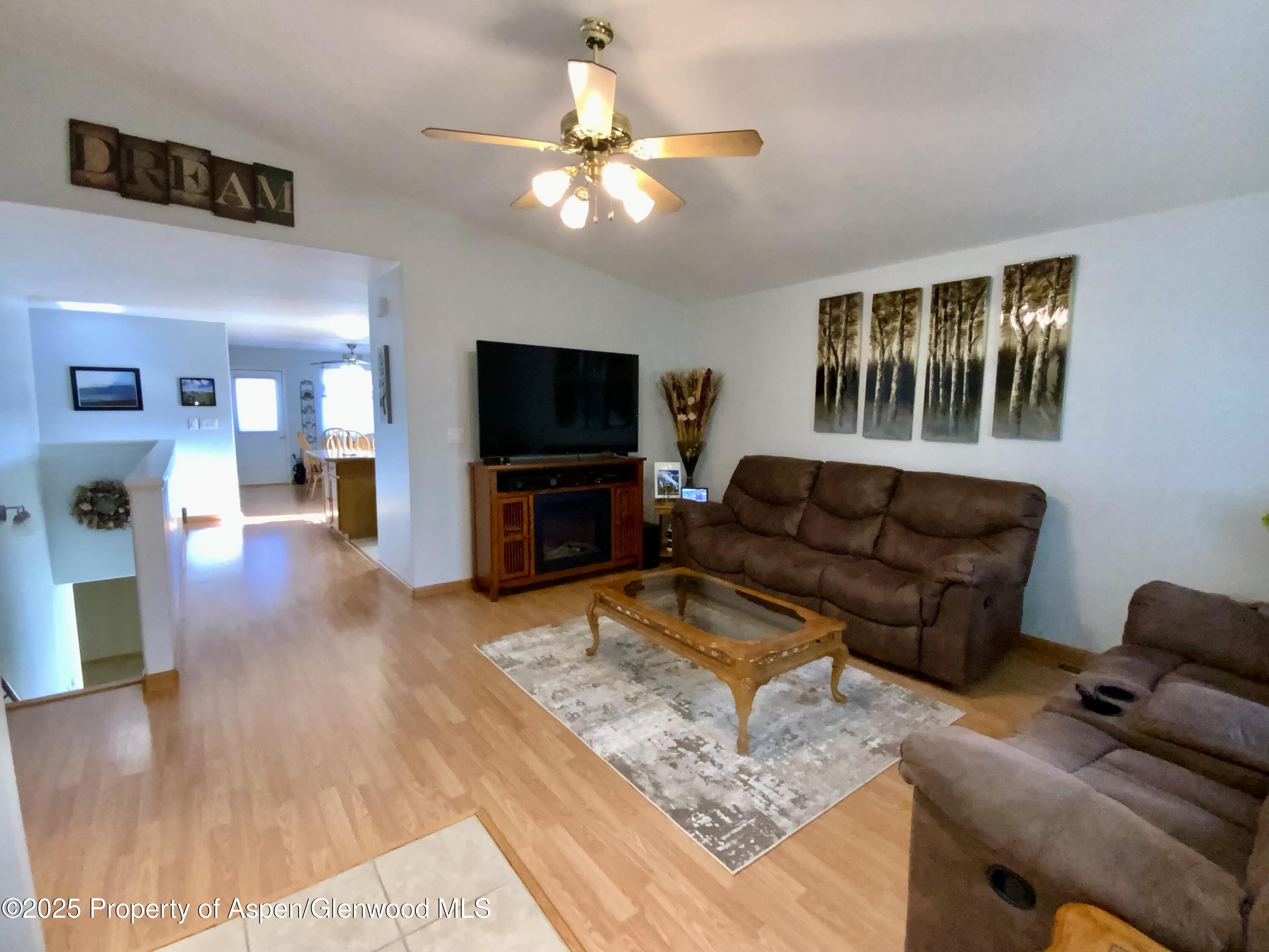 660 Aspen Avenue Rifle, CO 81650 - Photo 4 of 30 a living room with furniture and a flat screen tv