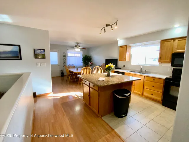 a kitchen with granite countertop a sink counter top space and stainless steel appliances