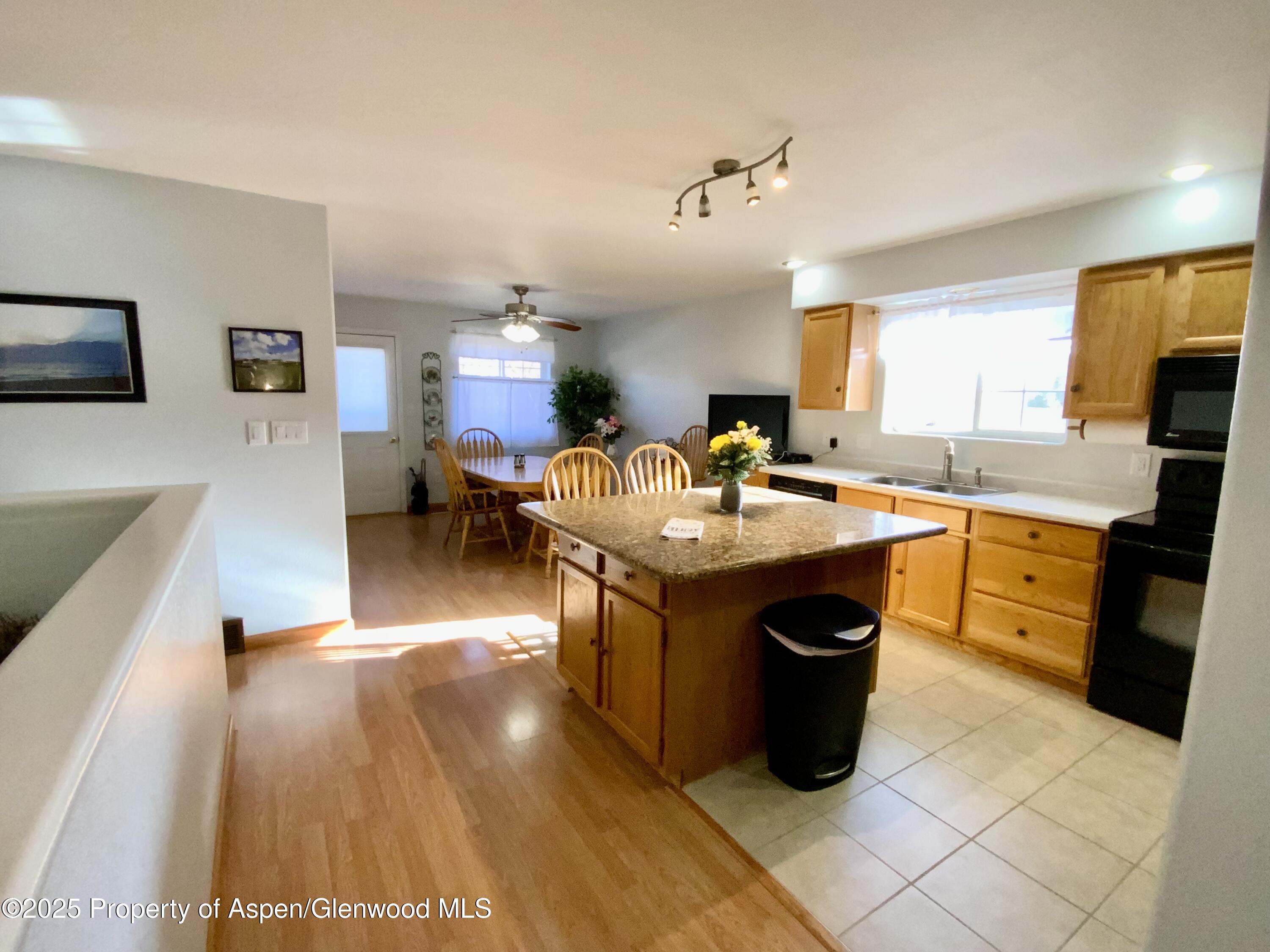 660 Aspen Avenue Rifle, CO 81650 - Photo 5 of 30 a kitchen with granite countertop a sink counter top space and stainless steel appliances