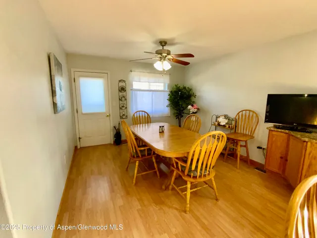 a view of a dining room with furniture and a flat screen tv