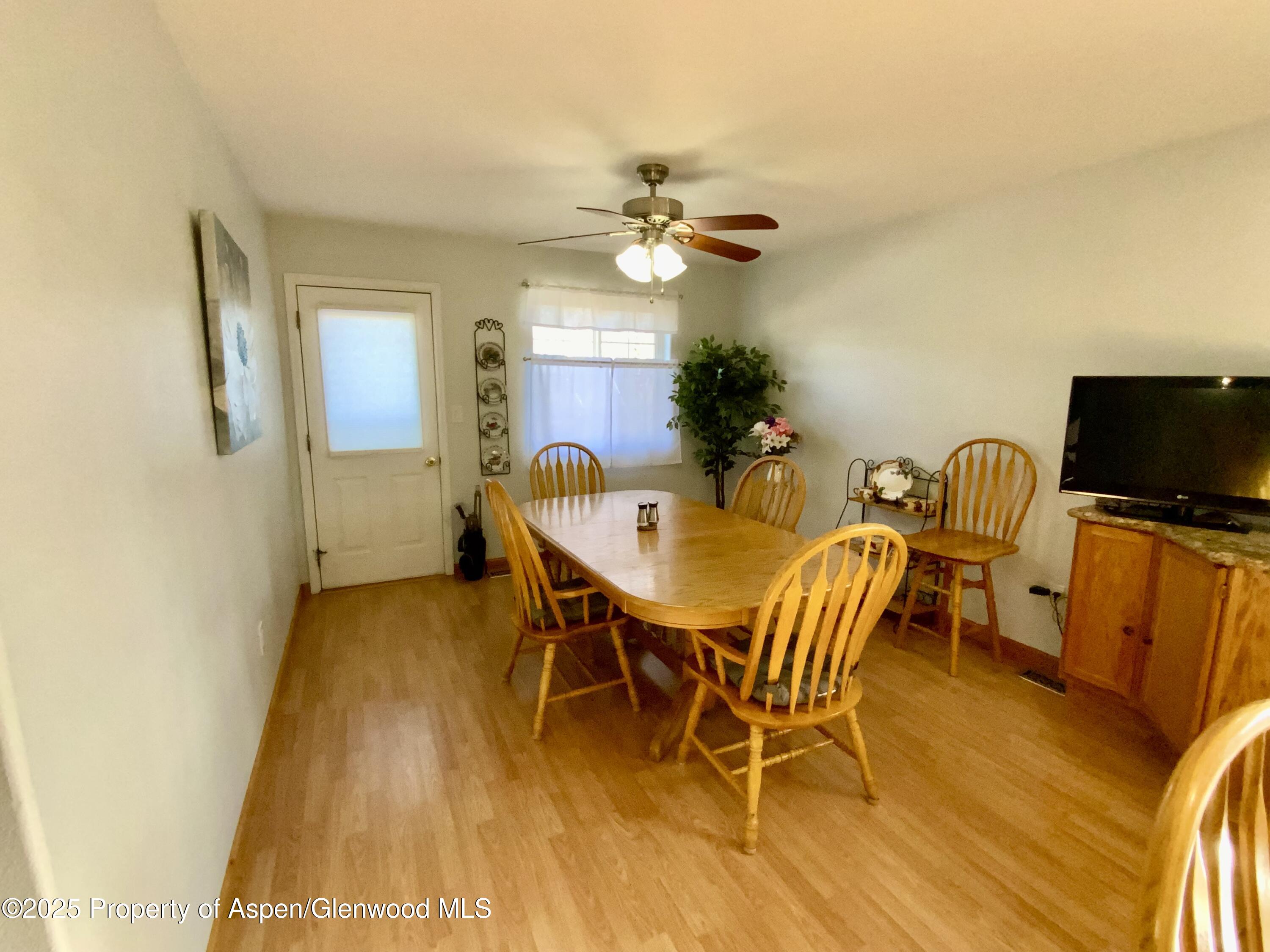 660 Aspen Avenue Rifle, CO 81650 - Photo 7 of 30 a view of a dining room with furniture and a flat screen tv