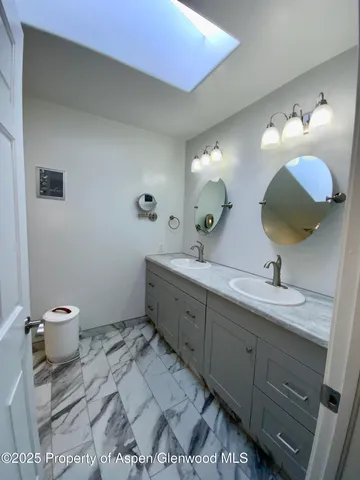 a spacious bathroom with a double vanity sink mirror and toilet