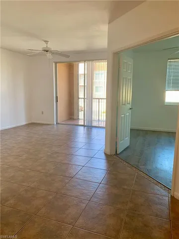 a view of a livingroom with an empty space and a window