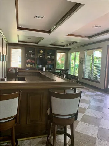 a kitchen with a table chairs sink and cabinets