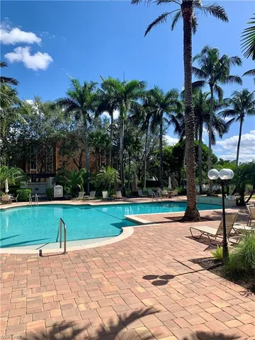 a view of a swimming pool with an outdoor space and seating area