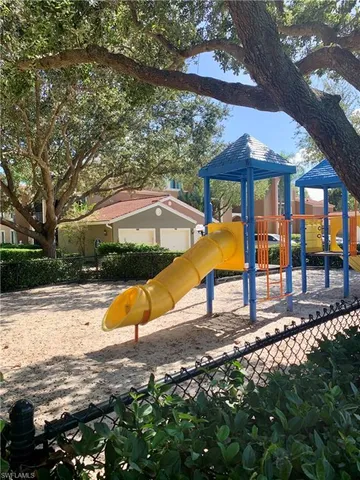 a view of pool with a table and chairs under an umbrella
