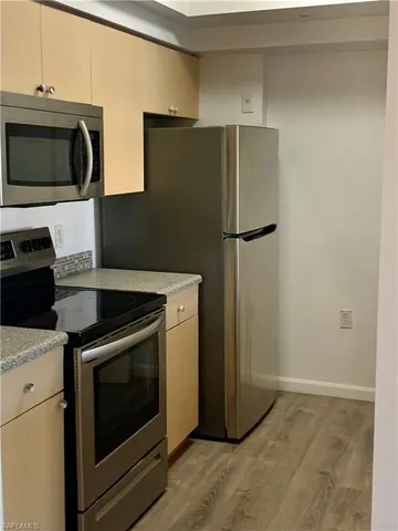 a kitchen with a refrigerator stove and microwave
