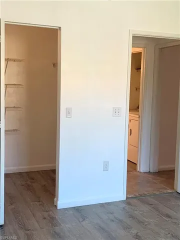 an empty room with wooden floor