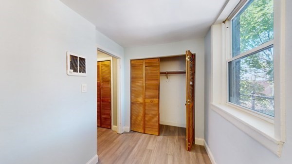 149 Winthrop Road, Unit 2 Brookline, MA 02445 - Photo 8 of 11 an empty room with wooden floor and windows