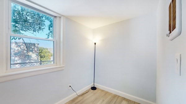 149 Winthrop Road, Unit 2 Brookline, MA 02445 - Photo 9 of 11 a view of empty room with wooden floor and fan